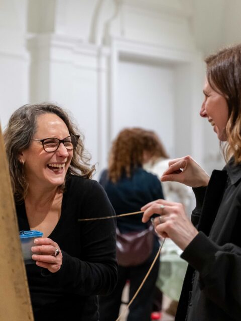 Two women painting in an art class