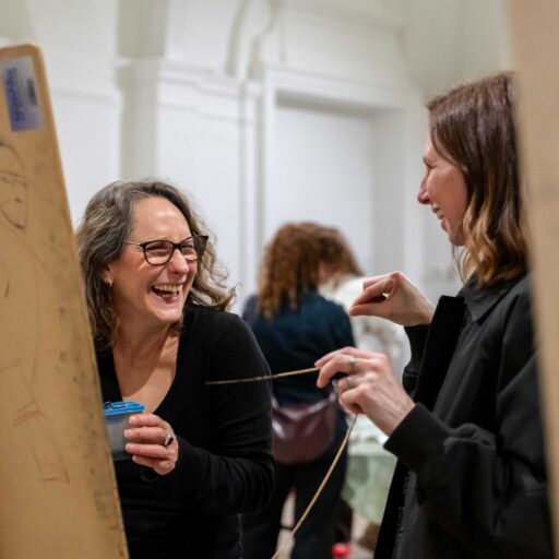 Two women painting in an art class